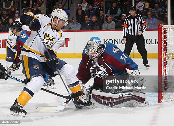 Colin Wilson of the Nashville Predators battles for the puck against goaltender Calvin Pickard of the Colorado Avalanche at the Pepsi Center on...