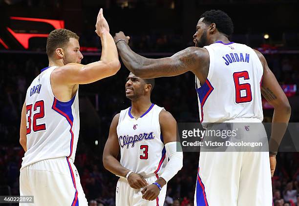 Blake Griffin of the Los Angeles Clippers celebrates with teammates Chris Paul and DeAndre Jordan after a scoring play in the second half during the...