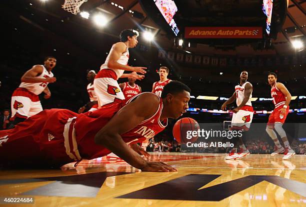 Troy Williams of the Indiana Hoosiers falls chasing the ball against the Louisville Cardinals during their game at the Jimmy V Classic in Madison...