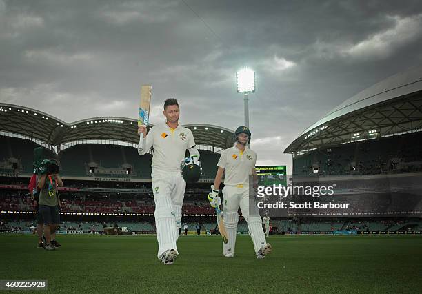 Michael Clarke of Australia and Steven Smith leave the field for a rain delay after Clarke reached his century during day two of the First Test match...