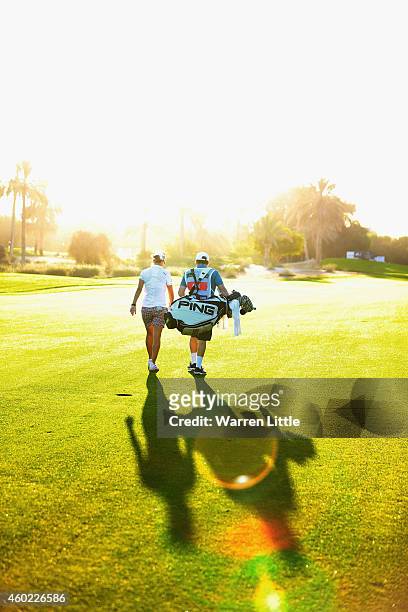 Lee-Anne Pace of South Africa walks up the 10th fairway with her caddie during the first round of the Omega Dubai Ladies Maters on the Majlis Course...
