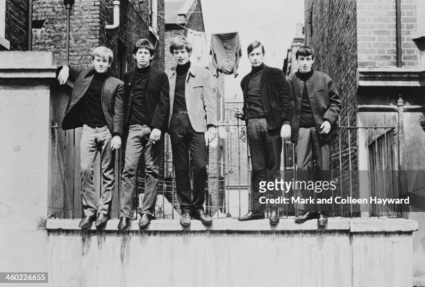 English rock and roll group The Rolling Stones standing on a wall in London, UK, 4th May 1963. Left to right: Brian Jones .Keith Richards, Mick...