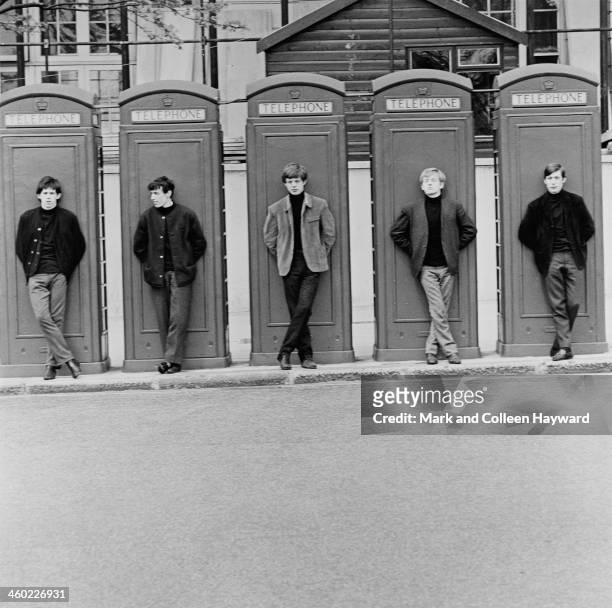 English rock and roll group The Rolling Stones posed standing in front of telephone boxes in London, UK, 4th May 1963. Left to right: Keith Richards,...