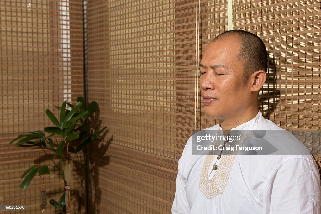 A traditional Chinese medicine practitioner sits in...