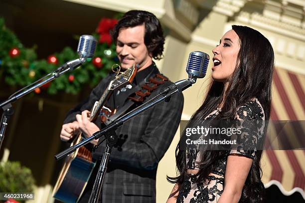 In this handout photo provided by Disney Parks, Alex Kinsey and Sierra Deaton of Alex & Sierra perform "Love Is An Open Door" from "Frozen" during...