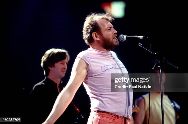 British musician Joe Cocker performs on stage during an ARMS Charity Concert, Dallas, Texas, November 27, 1983. In the background are fellow...