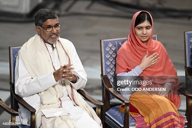 Nobel Peace Prize laureates Kailash Satyarthi and Malala Yousafzai salute the audience at the start of the Nobel Peace Prize awarding ceremony at the...