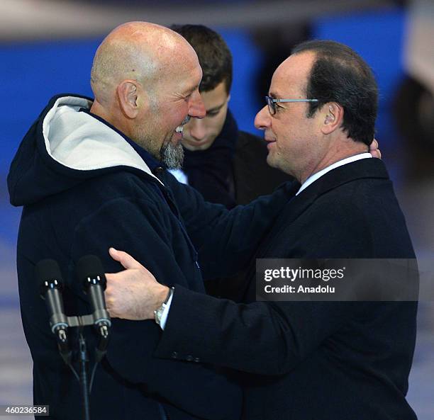 French President Francois Hollande greets Serge Lazarevic , France's last remaining hostage, after landing at the Villacoublay military base near...