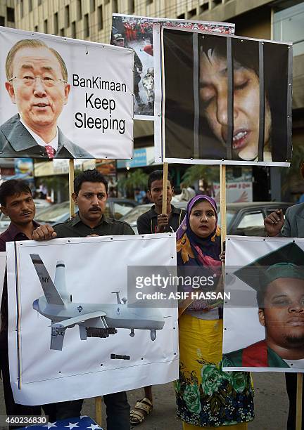 Pakistani demonstrators hold pictures of US police shooting victim Michael Brown and Aafia Siddiqui, a Pakistani scientist who is currently serving a...