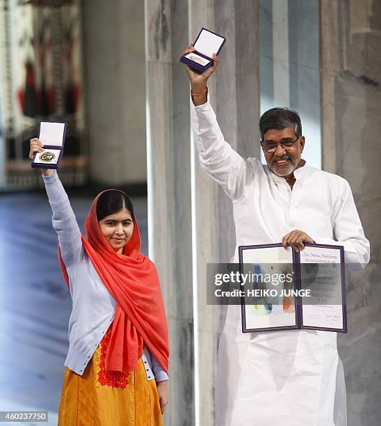 Nobel Peace Prize laureates Kailash Satyarthi and Malala Yousafzai display their medals and diplomas during the Nobel Peace Prize awards ceremony at...