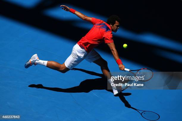 Jo-Wilfried Tsonga of France plays a backhand to Daniel Munoz-De La Nava of Spain in the men's singles match during day seven of the Hopman Cup at...