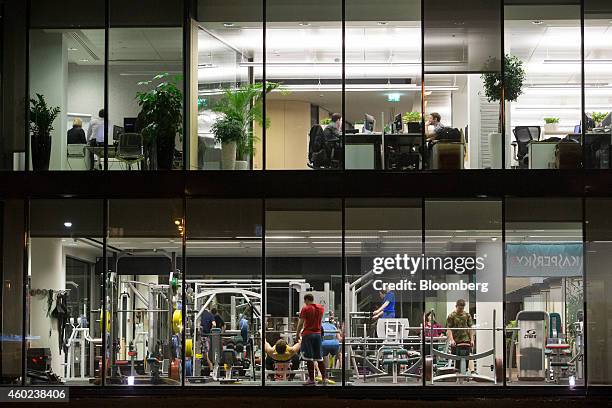 Employees train in a gym and work at their office desks at the headquarters of Kaspersky Lab, a cyber-security firm, in Moscow, Russia, on Tuesday,...