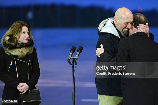 Former hostage, Serge Lazarevic is welcomed by French President Francois Hollande as his daughter Diane looks on after landing at the Villacoublay...