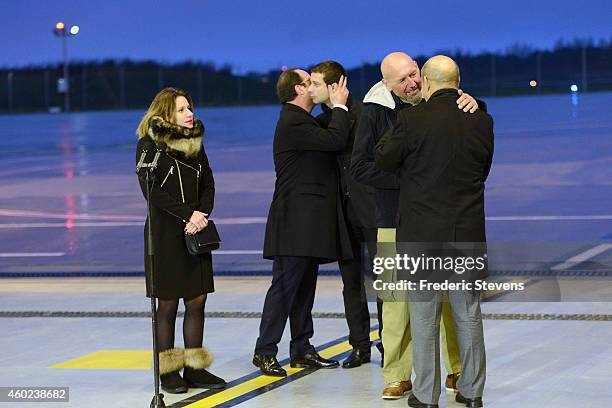 Former hostage, Serge Lazarevic is welcomed by French Defence Minister Jean-Yves Le Drian as French President Francois Hollande embraces Clement...