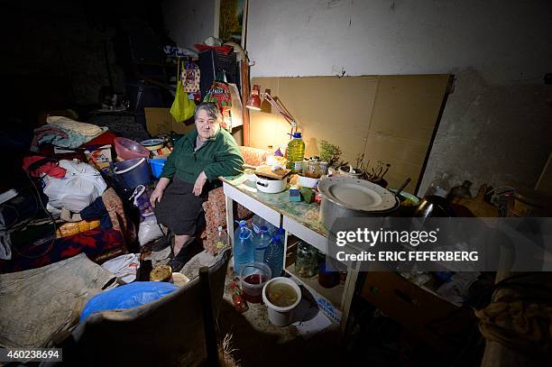 Woman sits in the cellar of her building used as a shelter in Kievskiy district witch is often sheld in the eastern Ukrain city of Donetsk ,...