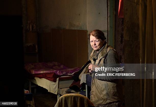 Woman stands in the cellar of her building used as a shelter cries in Kievskiy district witch is often sheld in the eastern Ukrain city of Donetsk ,...