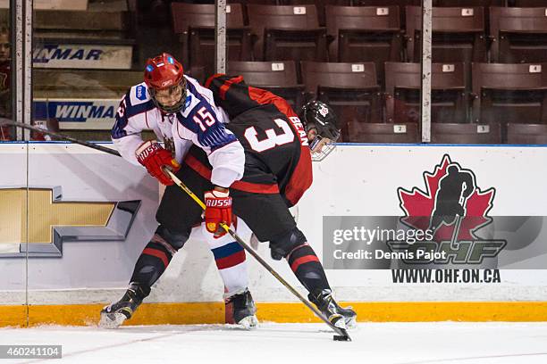 Georgi Ivanov of Russia battles for the puck against Jake Bean of Canada Black during the World Under-17 Hockey Challenge on November 2, 2014 at the...