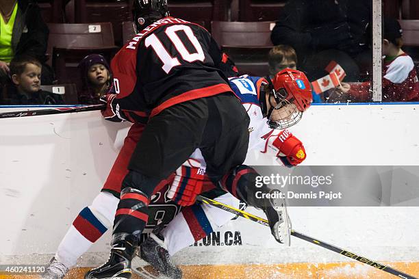 Beck Malenstyn of Canada Black places a hit on Georgi Ivanov of Russia during the World Under-17 Hockey Challenge on November 2, 2014 at the RBC...