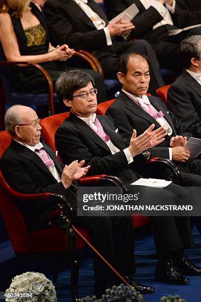 Nobel Physics laureates 2014 Isamu Akasaki, Hiroshi Amano and Shuji Nakamura sit on stage during the 2014 Nobel prize award ceremony at the Stockholm...
