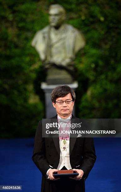 Nobel Physics laureate 2014 Hiroshi Amano of the Nagoya University poses with the Nobel Prize during the 2014 Nobel prize award ceremony at the...