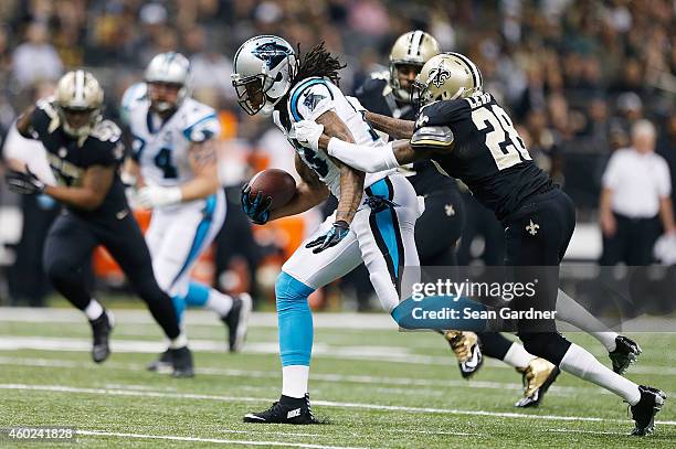 Kelvin Benjamin of the Carolina Panthers is tackled by Keenan Lewis of the New Orleans Saints during a game at the Mercedes-Benz Superdome on...