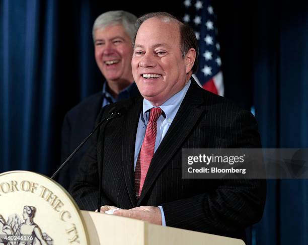 Mike Duggan, mayor of Detroit, speaks during a news conference with Rick Snyder, governor of Michigan, back left, at police headquarters in Detroit,...