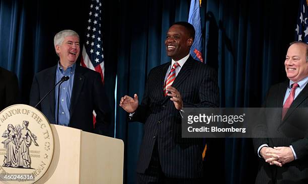 Kevyn Orr, emergency manager for Detroit, center, laughs during a news conference with Mike Duggan, mayor of Detroit, right, and Rick Snyder,...