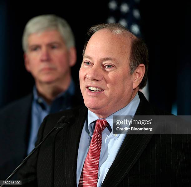 Mike Duggan, mayor of Detroit, speaks during a news conference with Rick Snyder, governor of Michigan, back left, at police headquarters in Detroit,...
