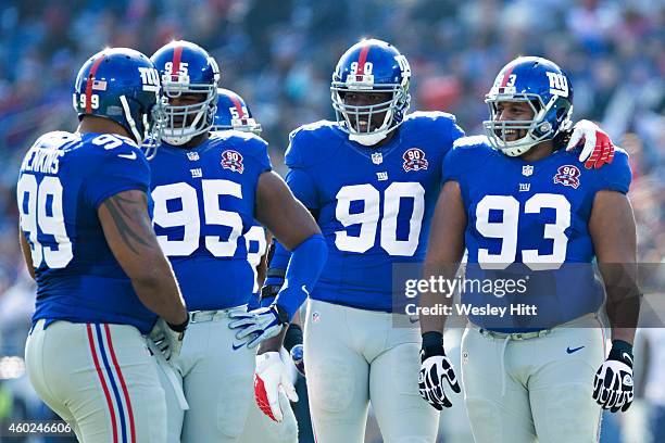 Cullen Jenkins, Johnathan Hankins, Mike Patterson and Jason Pierre-Paul of the New York Giants joke around at the line of scrimmage in the first...