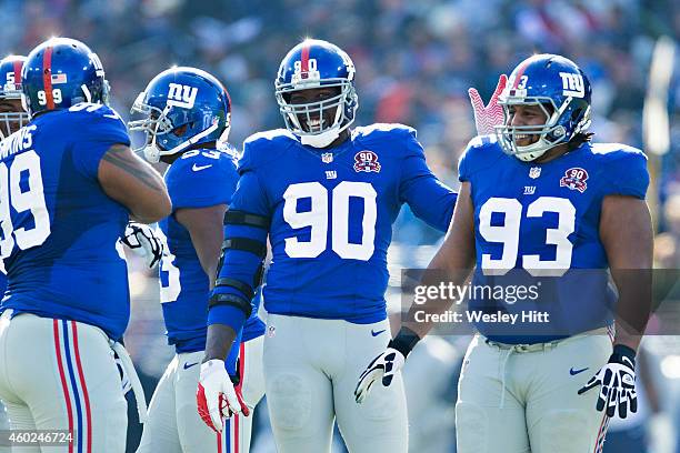 Cullen Jenkins, Johnathan Hankins, Mike Patterson and Jason Pierre-Paul of the New York Giants joke around at the line of scrimmage in the first...