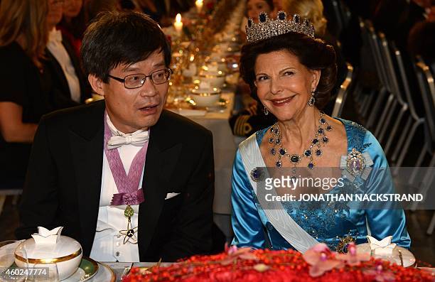 Queen Silvia of Sweden and the Nobel 2014 Prize in physics laureate Hiroshi Amano attend the Nobel banquet, a traditional dinner after the Nobel...