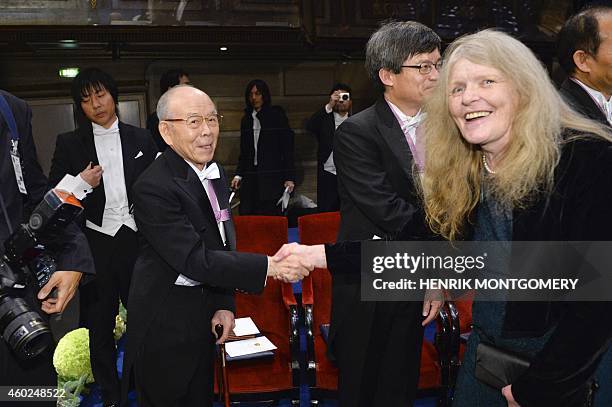 Nobel Physics laureate 2014 Isamu Akasaki from Japan shakes hands with Christina Lugn of the Swedish Academy after receiving his award during the...