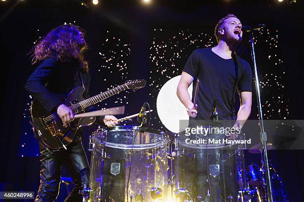 Daniel Wayne Sermon and Dan Reynolds of Imagine Dragons perform on stage during Deck The Hall Ball hosted by 107.7 The End at KeyArena on December 9,...