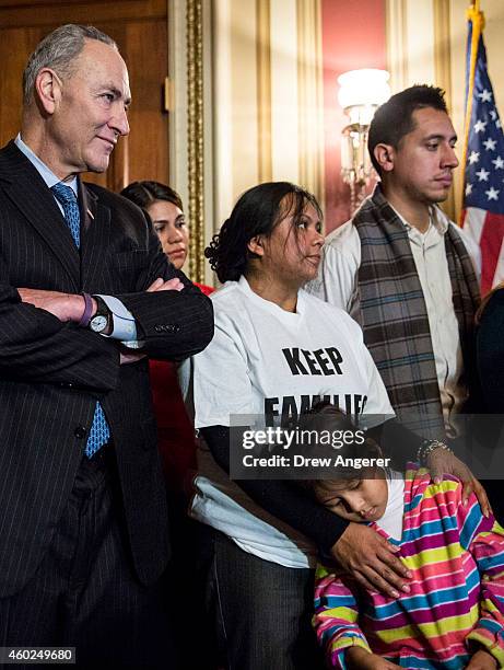 Sen. Charles Schumer , Madai Ledezma from Mexico, now living in Maryland, and her daughter Heather Pina-Ledezma look on during a news conference to...