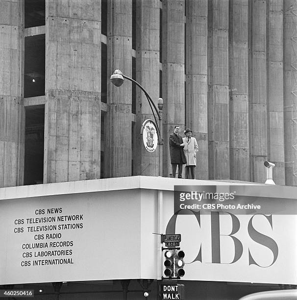Two unidentified CBS executives standing on sidewalk shed with CBS signage at CBS headquarters construction site. Corner of Sixth Avenue and West 52...