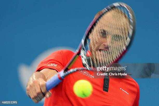 Marius Copil of Romania plays a backhand in his match against Lleyton Hewitt of Australia during day six of the 2014 Brisbane International at...
