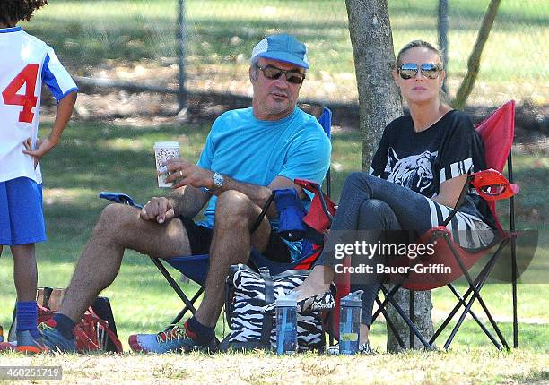 Heidi Klum sits on the sideline with Flavio Briatore as she watches her children, Leni, Johan and Lou play soccer in Brentwood on September 08, 2013...