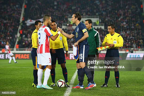 Mohamed Abarhoun of Moghreb Athletic Tetouan and Ivan Vicelich of Auckland City FC shaq's hands before the FIFA Club World Cup Play-Off for the...
