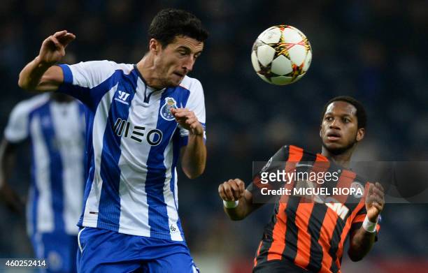 Porto's Spanish defender Ivan Marcano heads the ball next to Shakhtar Donetsk's Brazilian midfielder Fred during the UEFA Champions League Group H...