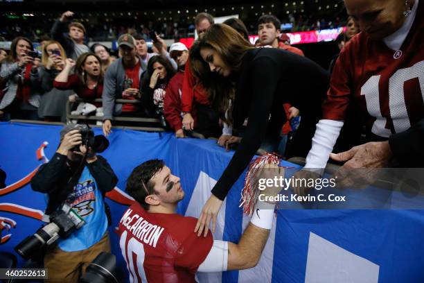 McCarron of the Alabama Crimson Tide talks wtih Katherine Webb after losing to Oklahoma Sooners 45-31 during the Allstate Sugar Bowl at the...