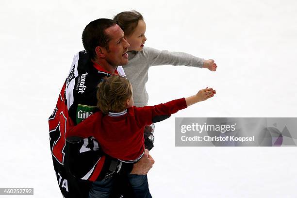 John Tripp of Koelner Haie celebrates with his children after the DEL Ice Hockey match between Koelner Haie and Augsburger Panther at Lanxess Arena...