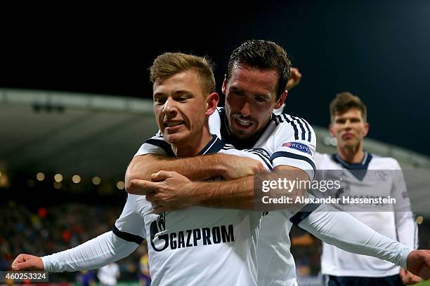 Max Meyer of Schalke celebrates scoring the opening goal with his team mates Christian Fuchs and Klaas-Jan Huntelaar during the UEFA Group G...