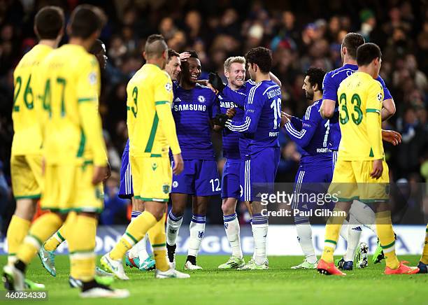 Mikel John Obi of Chelsea is congratulated by teammates after scoring his team's third goal during the UEFA Champions League group G match between...