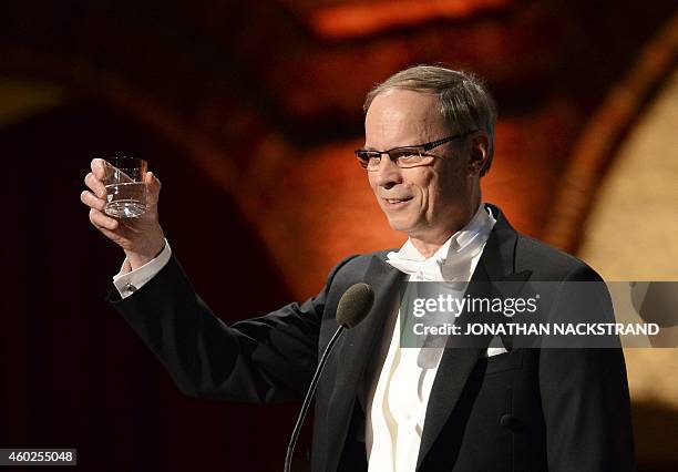 The 2014 Nobel economic sciences laureate French Jean Tirole from Toulouse 1 Capitole University, raises his glass as he addresses the traditional...