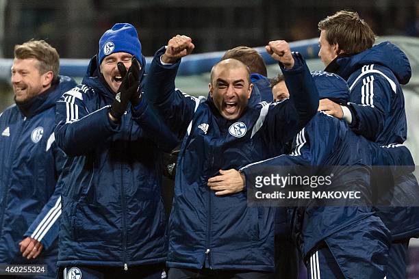 Schalke's head coach Roberto Di Matteo celebrates with his team after they qualifying for the next round of the UEFA Champions League after the Group...