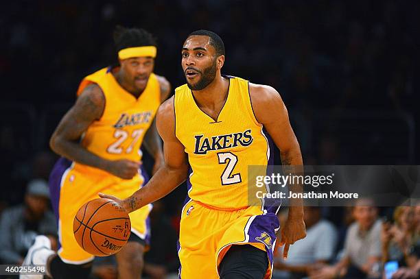 Wayne Ellington of the Los Angeles Lakers moves the ball upcourt during a game against the Sacramento Kings at Staples Center on December 9, 2014 in...