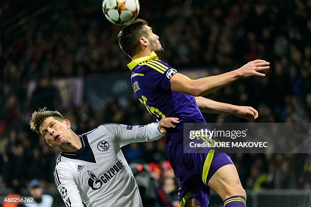 MariborÕs Aleksander Rajcevic vies for the ball with Forward Klaas Jan Huntelaar of Schalke 04 during the UEFA Champions League Group G football...