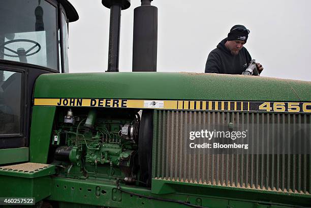 Michlig Energy driver Jake Gould delivers diesel fuel to a John Deere & Co. Tractor in Manlius, Illinois, U.S., on Wednesday, Dec. 10, 2014. Gasoline...