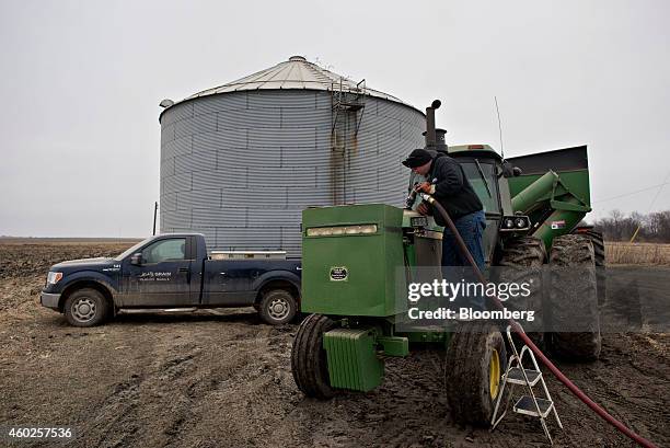 Michlig Energy driver Jake Gould delivers diesel fuel to a John Deere & Co. Tractor in Manlius, Illinois, U.S., on Wednesday, Dec. 10, 2014. Gasoline...