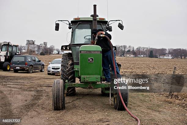 Michlig Energy driver Jake Gould delivers diesel fuel to a John Deere & Co. Tractor in Manlius, Illinois, U.S., on Wednesday, Dec. 10, 2014. Gasoline...